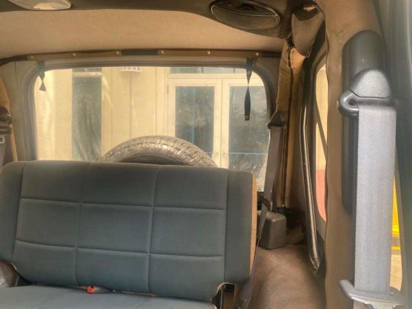 1999 Forest Green Pearl /Camel/Dark Green Jeep Wrangler Sahara AUYO AC 6 CYL LOW MILES 47,009 (1J4FY49S0XP) with an 4.0L SMPI I6 Power Tech Engine engine, Automatic transmission, located at 4701 North Dixie Hwy, Pompano Beach, FL, 33064, (954) 422-2889, 26.240938, -80.123474 - OUR WEBPAGE FLORIDACARS1.COM HAS OVER 100 PHOTOS AND FREE CARFAX LINK 1999 Jeep Wrangler Sahara Utility (Blazer, Jimmy, Scout, etc.) 4.0L I6 F Gasoline 20 MPG Rear Wheel Drive w/ 4X4 Features 4WD/AWD ABS Brakes Air Conditioning Alloy Wheels AM/FM Stereo Automatic Transmission Cassette Player CD Audi - Photo#76