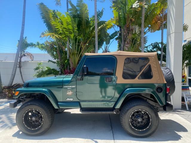 1999 Forest Green Pearl /Camel/Dark Green Jeep Wrangler Sahara AUYO AC 6 CYL LOW MILES 47,009 (1J4FY49S0XP) with an 4.0L SMPI I6 Power Tech Engine engine, Automatic transmission, located at 4701 North Dixie Hwy, Pompano Beach, FL, 33064, (954) 422-2889, 26.240938, -80.123474 - OUR WEBPAGE FLORIDACARS1.COM HAS OVER 100 PHOTOS AND FREE CARFAX LINK 1999 Jeep Wrangler Sahara Utility (Blazer, Jimmy, Scout, etc.) 4.0L I6 F Gasoline 20 MPG Rear Wheel Drive w/ 4X4 Features 4WD/AWD ABS Brakes Air Conditioning Alloy Wheels AM/FM Stereo Automatic Transmission Cassette Player CD Audi - Photo#4