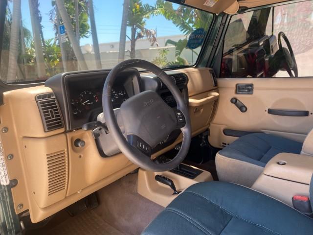 1999 Forest Green Pearl /Camel/Dark Green Jeep Wrangler Sahara AUYO AC 6 CYL LOW MILES 47,009 (1J4FY49S0XP) with an 4.0L SMPI I6 Power Tech Engine engine, Automatic transmission, located at 4701 North Dixie Hwy, Pompano Beach, FL, 33064, (954) 422-2889, 26.240938, -80.123474 - OUR WEBPAGE FLORIDACARS1.COM HAS OVER 100 PHOTOS AND FREE CARFAX LINK 1999 Jeep Wrangler Sahara Utility (Blazer, Jimmy, Scout, etc.) 4.0L I6 F Gasoline 20 MPG Rear Wheel Drive w/ 4X4 Features 4WD/AWD ABS Brakes Air Conditioning Alloy Wheels AM/FM Stereo Automatic Transmission Cassette Player CD Audi - Photo#50