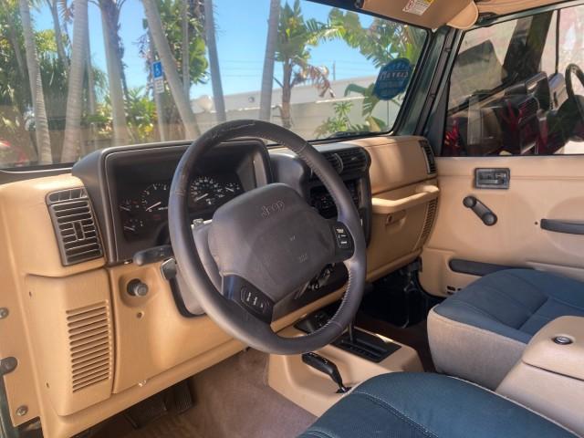 1999 Forest Green Pearl /Camel/Dark Green Jeep Wrangler Sahara AUYO AC 6 CYL LOW MILES 47,009 (1J4FY49S0XP) with an 4.0L SMPI I6 Power Tech Engine engine, Automatic transmission, located at 4701 North Dixie Hwy, Pompano Beach, FL, 33064, (954) 422-2889, 26.240938, -80.123474 - OUR WEBPAGE FLORIDACARS1.COM HAS OVER 100 PHOTOS AND FREE CARFAX LINK 1999 Jeep Wrangler Sahara Utility (Blazer, Jimmy, Scout, etc.) 4.0L I6 F Gasoline 20 MPG Rear Wheel Drive w/ 4X4 Features 4WD/AWD ABS Brakes Air Conditioning Alloy Wheels AM/FM Stereo Automatic Transmission Cassette Player CD Audi - Photo#51