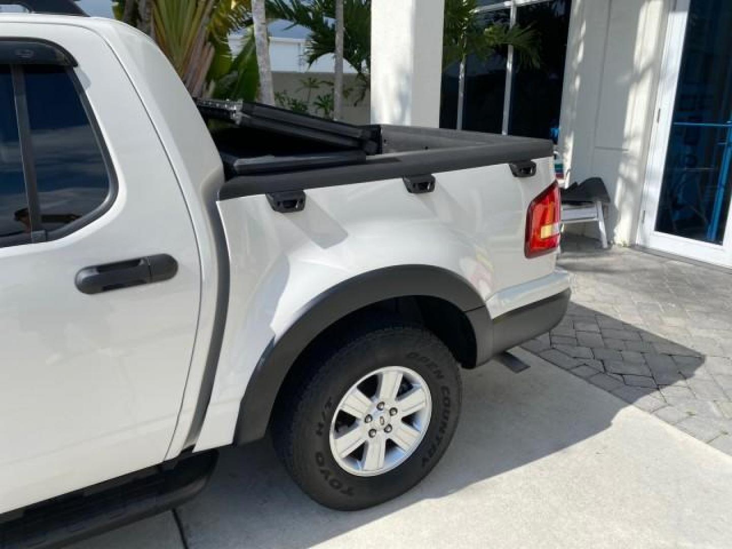 2009 White Suede /Camel Ford Explorer Sport Trac XLT LOW MILES 73,848 (1FMEU31E99U) with an 4.0L SOHC 12-Valve V6 Engine engine, Automatic transmission, located at 4701 North Dixie Hwy, Pompano Beach, FL, 33064, (954) 422-2889, 26.240938, -80.123474 - OUR WEBPAGE FLORIDACARS1.COM HAS OVER 100 PHOTOS AND FREE CARFAX LINK 2009 Ford Explorer Sport Trac XLT Sport Pickup 4.0L V6 F SOHC 12V Gasoline 21 MPG Rear Wheel Drive Features ABS Brakes Air Conditioning Alloy Wheels AM/FM Stereo Automatic Transmission Auxiliary Audio Input CD Audio Cloth Seats Cr - Photo#83