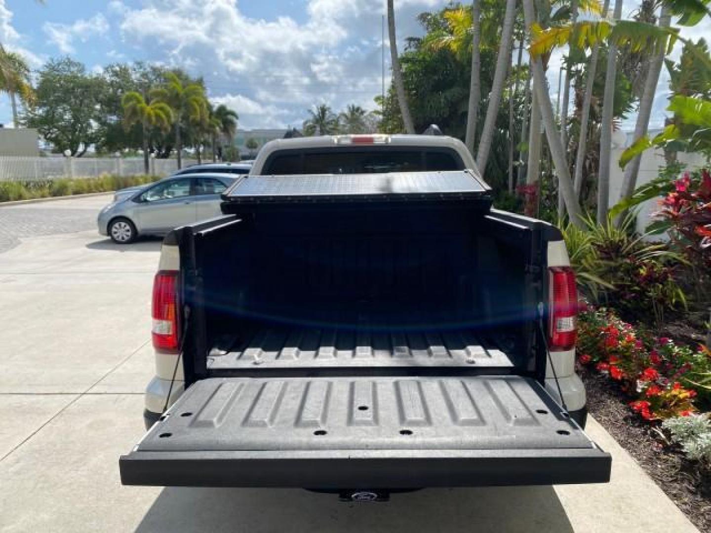 2009 White Suede /Camel Ford Explorer Sport Trac XLT LOW MILES 73,848 (1FMEU31E99U) with an 4.0L SOHC 12-Valve V6 Engine engine, Automatic transmission, located at 4701 North Dixie Hwy, Pompano Beach, FL, 33064, (954) 422-2889, 26.240938, -80.123474 - OUR WEBPAGE FLORIDACARS1.COM HAS OVER 100 PHOTOS AND FREE CARFAX LINK 2009 Ford Explorer Sport Trac XLT Sport Pickup 4.0L V6 F SOHC 12V Gasoline 21 MPG Rear Wheel Drive Features ABS Brakes Air Conditioning Alloy Wheels AM/FM Stereo Automatic Transmission Auxiliary Audio Input CD Audio Cloth Seats Cr - Photo#86