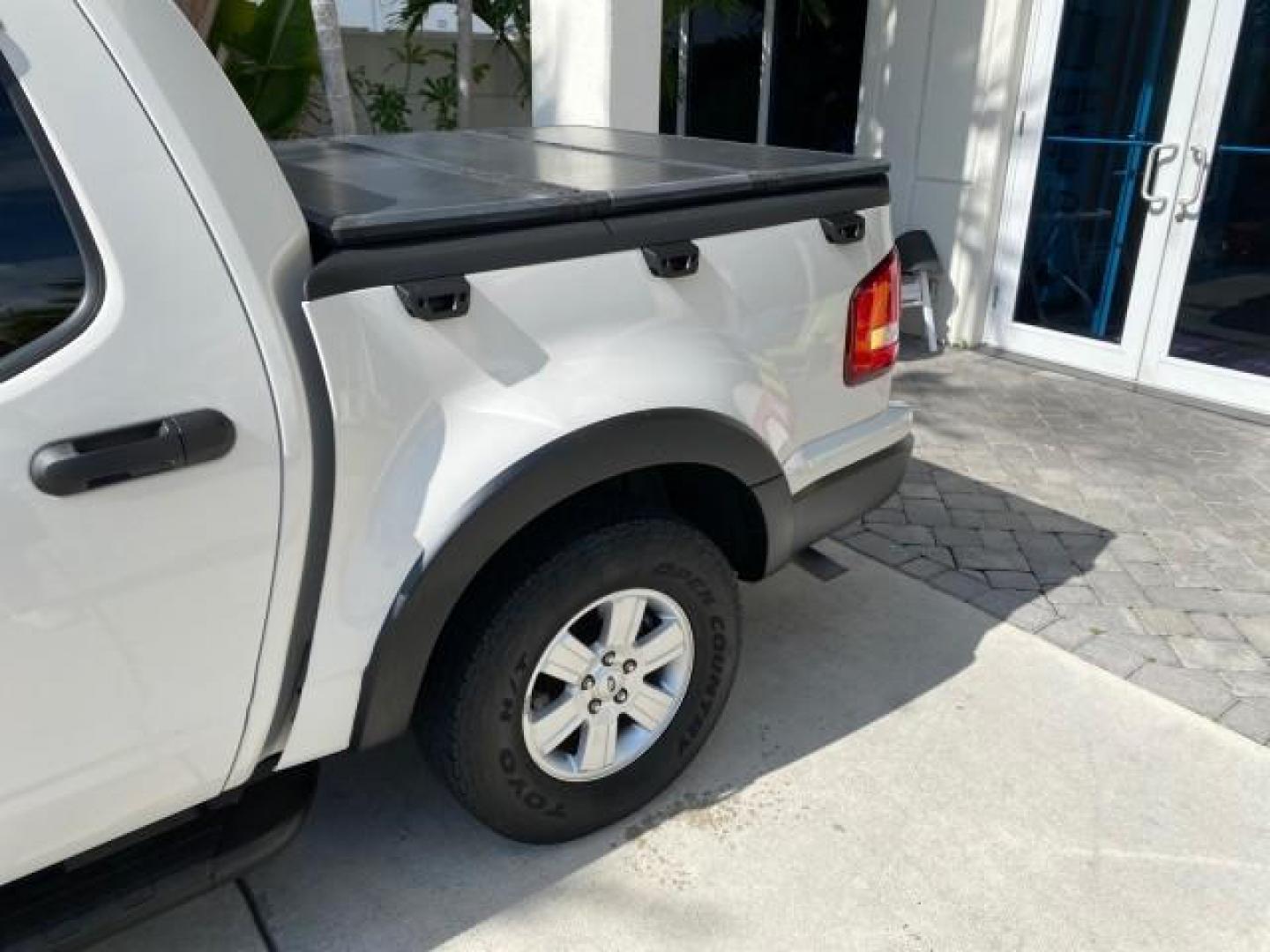 2009 White Suede /Camel Ford Explorer Sport Trac XLT LOW MILES 73,848 (1FMEU31E99U) with an 4.0L SOHC 12-Valve V6 Engine engine, Automatic transmission, located at 4701 North Dixie Hwy, Pompano Beach, FL, 33064, (954) 422-2889, 26.240938, -80.123474 - OUR WEBPAGE FLORIDACARS1.COM HAS OVER 100 PHOTOS AND FREE CARFAX LINK 2009 Ford Explorer Sport Trac XLT Sport Pickup 4.0L V6 F SOHC 12V Gasoline 21 MPG Rear Wheel Drive Features ABS Brakes Air Conditioning Alloy Wheels AM/FM Stereo Automatic Transmission Auxiliary Audio Input CD Audio Cloth Seats Cr - Photo#92