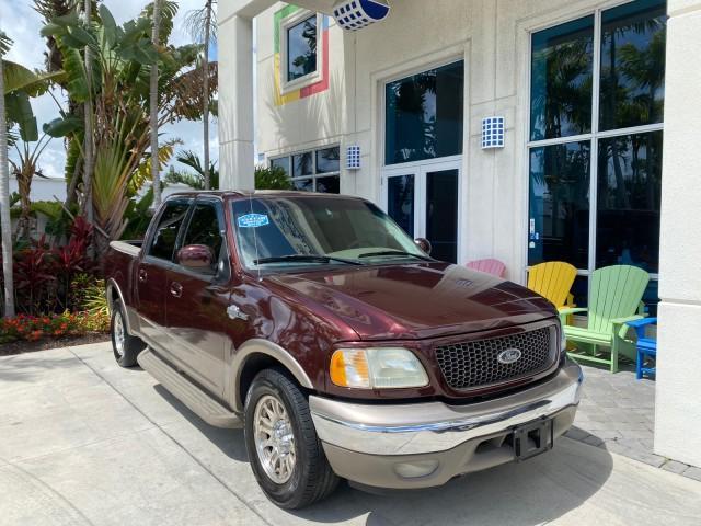 2002 Toreador Red Metallic /Dark Brown Ford F-150 CREW CAB King Ranch LOW MILES 56,886 (1FTRW07L12K) with an 5.4L SEFI OHC V8 Triton Engine engine, Automatic transmission, located at 4701 North Dixie Hwy, Pompano Beach, FL, 33064, (954) 422-2889, 26.240938, -80.123474 - OUR WEBPAGE FLORIDACARS1.COM HAS OVER 100 PHOTOS AND FREE CARFAX LINK 2002 Ford F-150 King Ranch Crew Pickup 5.4L V8 F SOHC 16V Gasoline 19 MPG Rear Wheel Drive Features ABS Brakes Air Conditioning Alloy Wheels AM/FM Stereo Automatic Transmission Bed Liner Cassette Player Cruise Control Leather Seat - Photo#1