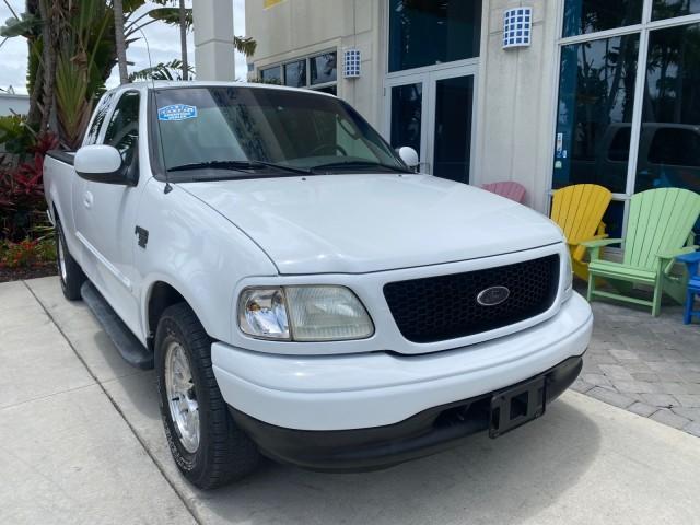 2003 Oxford White /Medium Graphite Ford F-150 XLT SPORT LOW MILES 70,700 1 OWNER (2FTRX17L63C) with an 5.4L 8-Cyl Engine engine, Automatic transmission, located at 4701 North Dixie Hwy, Pompano Beach, FL, 33064, (954) 422-2889, 26.240938, -80.123474 - OUR WEBPAGE FLORIDACARS1.COM HAS OVER 100 PHOTOS AND FREE CARFAX LINK 2003 Ford F-150 XLT 4 Door Extended Cab Pickup 5.4L V8 F SOHC 16V Gasoline 20 MPG Rear Wheel Drive Features ABS Brakes Air Conditioning Alloy Wheels AM/FM Stereo Automatic Transmission Auxiliary Audio Input Bluetooth Technology CD - Photo#1