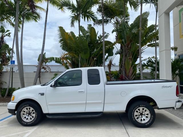 2003 Oxford White /Medium Graphite Ford F-150 XLT SPORT LOW MILES 70,700 1 OWNER (2FTRX17L63C) with an 5.4L 8-Cyl Engine engine, Automatic transmission, located at 4701 North Dixie Hwy, Pompano Beach, FL, 33064, (954) 422-2889, 26.240938, -80.123474 - OUR WEBPAGE FLORIDACARS1.COM HAS OVER 100 PHOTOS AND FREE CARFAX LINK 2003 Ford F-150 XLT 4 Door Extended Cab Pickup 5.4L V8 F SOHC 16V Gasoline 20 MPG Rear Wheel Drive Features ABS Brakes Air Conditioning Alloy Wheels AM/FM Stereo Automatic Transmission Auxiliary Audio Input Bluetooth Technology CD - Photo#30