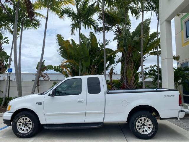 2003 Oxford White /Medium Graphite Ford F-150 XLT SPORT LOW MILES 70,700 1 OWNER (2FTRX17L63C) with an 5.4L 8-Cyl Engine engine, Automatic transmission, located at 4701 North Dixie Hwy, Pompano Beach, FL, 33064, (954) 422-2889, 26.240938, -80.123474 - OUR WEBPAGE FLORIDACARS1.COM HAS OVER 100 PHOTOS AND FREE CARFAX LINK 2003 Ford F-150 XLT 4 Door Extended Cab Pickup 5.4L V8 F SOHC 16V Gasoline 20 MPG Rear Wheel Drive Features ABS Brakes Air Conditioning Alloy Wheels AM/FM Stereo Automatic Transmission Auxiliary Audio Input Bluetooth Technology CD - Photo#31