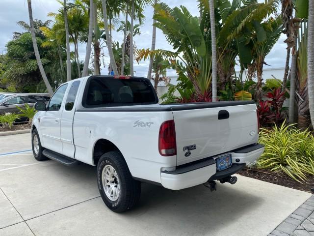 2003 Oxford White /Medium Graphite Ford F-150 XLT SPORT LOW MILES 70,700 1 OWNER (2FTRX17L63C) with an 5.4L 8-Cyl Engine engine, Automatic transmission, located at 4701 North Dixie Hwy, Pompano Beach, FL, 33064, (954) 422-2889, 26.240938, -80.123474 - OUR WEBPAGE FLORIDACARS1.COM HAS OVER 100 PHOTOS AND FREE CARFAX LINK 2003 Ford F-150 XLT 4 Door Extended Cab Pickup 5.4L V8 F SOHC 16V Gasoline 20 MPG Rear Wheel Drive Features ABS Brakes Air Conditioning Alloy Wheels AM/FM Stereo Automatic Transmission Auxiliary Audio Input Bluetooth Technology CD - Photo#32