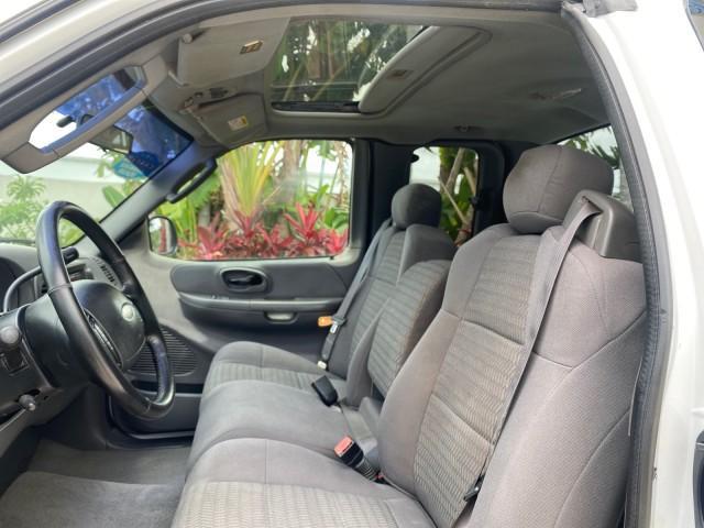 2003 Oxford White /Medium Graphite Ford F-150 XLT SPORT LOW MILES 70,700 1 OWNER (2FTRX17L63C) with an 5.4L 8-Cyl Engine engine, Automatic transmission, located at 4701 North Dixie Hwy, Pompano Beach, FL, 33064, (954) 422-2889, 26.240938, -80.123474 - OUR WEBPAGE FLORIDACARS1.COM HAS OVER 100 PHOTOS AND FREE CARFAX LINK 2003 Ford F-150 XLT 4 Door Extended Cab Pickup 5.4L V8 F SOHC 16V Gasoline 20 MPG Rear Wheel Drive Features ABS Brakes Air Conditioning Alloy Wheels AM/FM Stereo Automatic Transmission Auxiliary Audio Input Bluetooth Technology CD - Photo#44