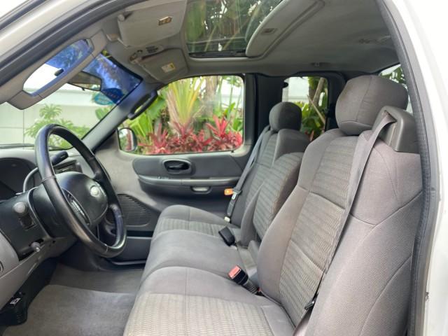 2003 Oxford White /Medium Graphite Ford F-150 XLT SPORT LOW MILES 70,700 1 OWNER (2FTRX17L63C) with an 5.4L 8-Cyl Engine engine, Automatic transmission, located at 4701 North Dixie Hwy, Pompano Beach, FL, 33064, (954) 422-2889, 26.240938, -80.123474 - OUR WEBPAGE FLORIDACARS1.COM HAS OVER 100 PHOTOS AND FREE CARFAX LINK 2003 Ford F-150 XLT 4 Door Extended Cab Pickup 5.4L V8 F SOHC 16V Gasoline 20 MPG Rear Wheel Drive Features ABS Brakes Air Conditioning Alloy Wheels AM/FM Stereo Automatic Transmission Auxiliary Audio Input Bluetooth Technology CD - Photo#45