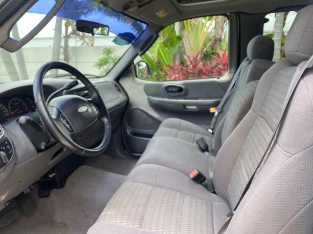 2003 Oxford White /Medium Graphite Ford F-150 XLT SPORT LOW MILES 70,700 1 OWNER (2FTRX17L63C) with an 5.4L 8-Cyl Engine engine, Automatic transmission, located at 4701 North Dixie Hwy, Pompano Beach, FL, 33064, (954) 422-2889, 26.240938, -80.123474 - OUR WEBPAGE FLORIDACARS1.COM HAS OVER 100 PHOTOS AND FREE CARFAX LINK 2003 Ford F-150 XLT 4 Door Extended Cab Pickup 5.4L V8 F SOHC 16V Gasoline 20 MPG Rear Wheel Drive Features ABS Brakes Air Conditioning Alloy Wheels AM/FM Stereo Automatic Transmission Auxiliary Audio Input Bluetooth Technology CD - Photo#46