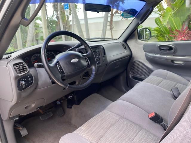 2003 Oxford White /Medium Graphite Ford F-150 XLT SPORT LOW MILES 70,700 1 OWNER (2FTRX17L63C) with an 5.4L 8-Cyl Engine engine, Automatic transmission, located at 4701 North Dixie Hwy, Pompano Beach, FL, 33064, (954) 422-2889, 26.240938, -80.123474 - OUR WEBPAGE FLORIDACARS1.COM HAS OVER 100 PHOTOS AND FREE CARFAX LINK 2003 Ford F-150 XLT 4 Door Extended Cab Pickup 5.4L V8 F SOHC 16V Gasoline 20 MPG Rear Wheel Drive Features ABS Brakes Air Conditioning Alloy Wheels AM/FM Stereo Automatic Transmission Auxiliary Audio Input Bluetooth Technology CD - Photo#48