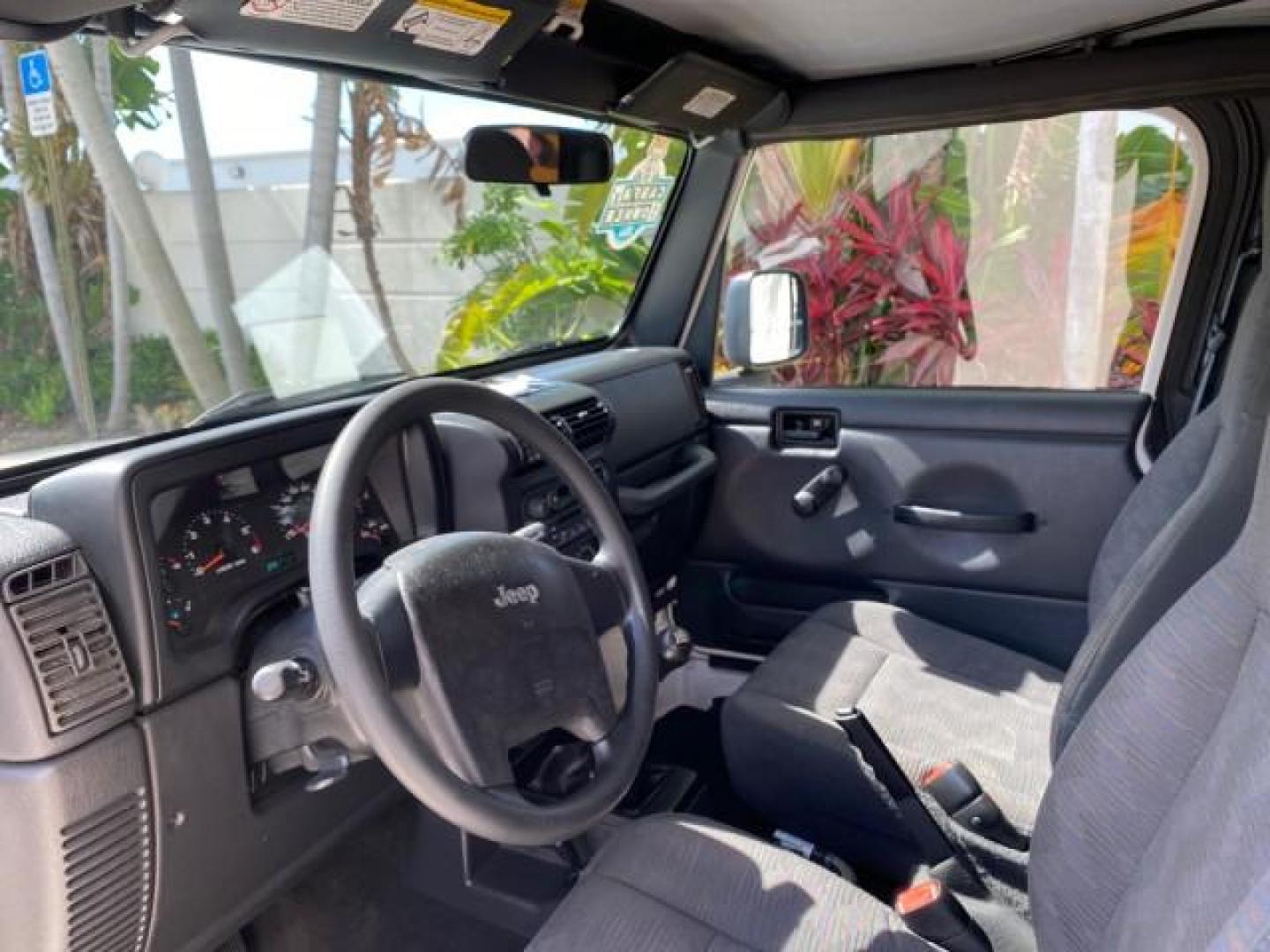 2005 Stone White /Dark Slate Gray Jeep Wrangler SE 4WD LOW MILES 29,371 1 OWNER (1J4FA29105P) with an 2.4L SMPI DOHC 16v 4-Cyl Engine engine, Manual transmission, located at 4701 North Dixie Hwy, Pompano Beach, FL, 33064, (954) 422-2889, 26.240938, -80.123474 - OUR WEBPAGE FLORIDACARS1.COM HAS OVER 100 PHOTOS AND FREE CARFAX LINK 2005 Jeep Wrangler SE 4WD 1 OWNER FACTORY ICE COLD AC 6 SPEED MANUAL Utility 2.4L I4 F Gasoline 21 MPG Rear Wheel Drive w/ 4X4 Features 4WD/AWD Air Conditioning Alloy Wheels AM/FM Stereo CD Audio Cloth Seats Manual Transmission So- Photo#46