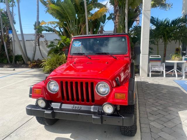 1999 Flame Red /Agate Jeep Wrangler Sport AUTO AC 4.0 6 CYL LOW MILES 92,727 (1J4FY19S2XP) with an 4.0L SMPI I6 Power Tech Engine engine, Automatic transmission, located at 4701 North Dixie Hwy, Pompano Beach, FL, 33064, (954) 422-2889, 26.240938, -80.123474 - OUR WEBPAGE FLORIDACARS1.COM HAS OVER 100 PHOTOS AND FREE CARFAX LINK 1999 Jeep Wrangler Sport 4WD Utility 4.0L I6 F Gasoline 20 MPG Rear Wheel Drive w/ 4X4 Features 4WD/AWD Air Conditioning Alloy Wheels AM/FM Stereo Automatic Transmission CD Audio Cloth Seats Cruise Control Running Boards Soft Top- Photo#3
