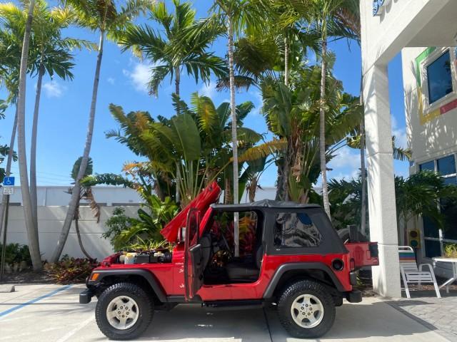 1999 Flame Red /Agate Jeep Wrangler Sport AUTO AC 4.0 6 CYL LOW MILES 92,727 (1J4FY19S2XP) with an 4.0L SMPI I6 Power Tech Engine engine, Automatic transmission, located at 4701 North Dixie Hwy, Pompano Beach, FL, 33064, (954) 422-2889, 26.240938, -80.123474 - OUR WEBPAGE FLORIDACARS1.COM HAS OVER 100 PHOTOS AND FREE CARFAX LINK 1999 Jeep Wrangler Sport 4WD Utility 4.0L I6 F Gasoline 20 MPG Rear Wheel Drive w/ 4X4 Features 4WD/AWD Air Conditioning Alloy Wheels AM/FM Stereo Automatic Transmission CD Audio Cloth Seats Cruise Control Running Boards Soft Top- Photo#8