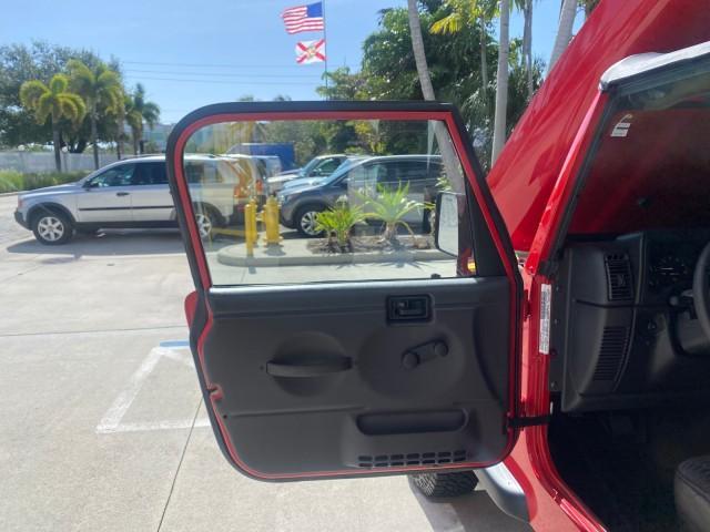 1999 Flame Red /Agate Jeep Wrangler Sport AUTO AC 4.0 6 CYL LOW MILES 92,727 (1J4FY19S2XP) with an 4.0L SMPI I6 Power Tech Engine engine, Automatic transmission, located at 4701 North Dixie Hwy, Pompano Beach, FL, 33064, (954) 422-2889, 26.240938, -80.123474 - OUR WEBPAGE FLORIDACARS1.COM HAS OVER 100 PHOTOS AND FREE CARFAX LINK 1999 Jeep Wrangler Sport 4WD Utility 4.0L I6 F Gasoline 20 MPG Rear Wheel Drive w/ 4X4 Features 4WD/AWD Air Conditioning Alloy Wheels AM/FM Stereo Automatic Transmission CD Audio Cloth Seats Cruise Control Running Boards Soft Top- Photo#9
