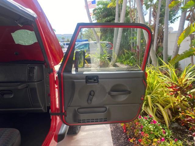 1999 Flame Red /Agate Jeep Wrangler Sport AUTO AC 4.0 6 CYL LOW MILES 92,727 (1J4FY19S2XP) with an 4.0L SMPI I6 Power Tech Engine engine, Automatic transmission, located at 4701 North Dixie Hwy, Pompano Beach, FL, 33064, (954) 422-2889, 26.240938, -80.123474 - OUR WEBPAGE FLORIDACARS1.COM HAS OVER 100 PHOTOS AND FREE CARFAX LINK 1999 Jeep Wrangler Sport 4WD Utility 4.0L I6 F Gasoline 20 MPG Rear Wheel Drive w/ 4X4 Features 4WD/AWD Air Conditioning Alloy Wheels AM/FM Stereo Automatic Transmission CD Audio Cloth Seats Cruise Control Running Boards Soft Top- Photo#11