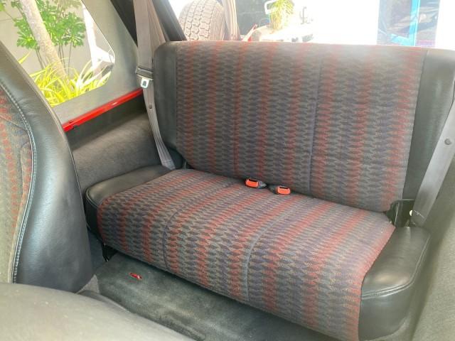 1999 Flame Red /Agate Jeep Wrangler Sport AUTO AC 4.0 6 CYL LOW MILES 92,727 (1J4FY19S2XP) with an 4.0L SMPI I6 Power Tech Engine engine, Automatic transmission, located at 4701 North Dixie Hwy, Pompano Beach, FL, 33064, (954) 422-2889, 26.240938, -80.123474 - OUR WEBPAGE FLORIDACARS1.COM HAS OVER 100 PHOTOS AND FREE CARFAX LINK 1999 Jeep Wrangler Sport 4WD Utility 4.0L I6 F Gasoline 20 MPG Rear Wheel Drive w/ 4X4 Features 4WD/AWD Air Conditioning Alloy Wheels AM/FM Stereo Automatic Transmission CD Audio Cloth Seats Cruise Control Running Boards Soft Top- Photo#14