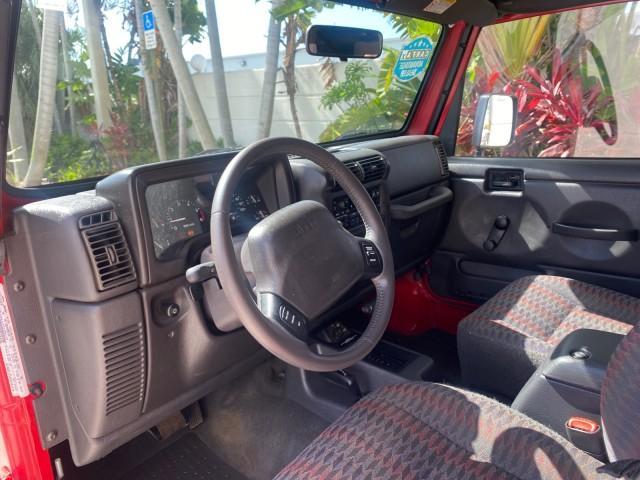1999 Flame Red /Agate Jeep Wrangler Sport AUTO AC 4.0 6 CYL LOW MILES 92,727 (1J4FY19S2XP) with an 4.0L SMPI I6 Power Tech Engine engine, Automatic transmission, located at 4701 North Dixie Hwy, Pompano Beach, FL, 33064, (954) 422-2889, 26.240938, -80.123474 - OUR WEBPAGE FLORIDACARS1.COM HAS OVER 100 PHOTOS AND FREE CARFAX LINK 1999 Jeep Wrangler Sport 4WD Utility 4.0L I6 F Gasoline 20 MPG Rear Wheel Drive w/ 4X4 Features 4WD/AWD Air Conditioning Alloy Wheels AM/FM Stereo Automatic Transmission CD Audio Cloth Seats Cruise Control Running Boards Soft Top- Photo#48