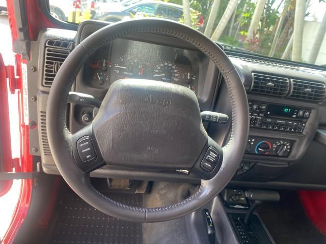 1999 Flame Red /Agate Jeep Wrangler Sport AUTO AC 4.0 6 CYL LOW MILES 92,727 (1J4FY19S2XP) with an 4.0L SMPI I6 Power Tech Engine engine, Automatic transmission, located at 4701 North Dixie Hwy, Pompano Beach, FL, 33064, (954) 422-2889, 26.240938, -80.123474 - OUR WEBPAGE FLORIDACARS1.COM HAS OVER 100 PHOTOS AND FREE CARFAX LINK 1999 Jeep Wrangler Sport 4WD Utility 4.0L I6 F Gasoline 20 MPG Rear Wheel Drive w/ 4X4 Features 4WD/AWD Air Conditioning Alloy Wheels AM/FM Stereo Automatic Transmission CD Audio Cloth Seats Cruise Control Running Boards Soft Top- Photo#50
