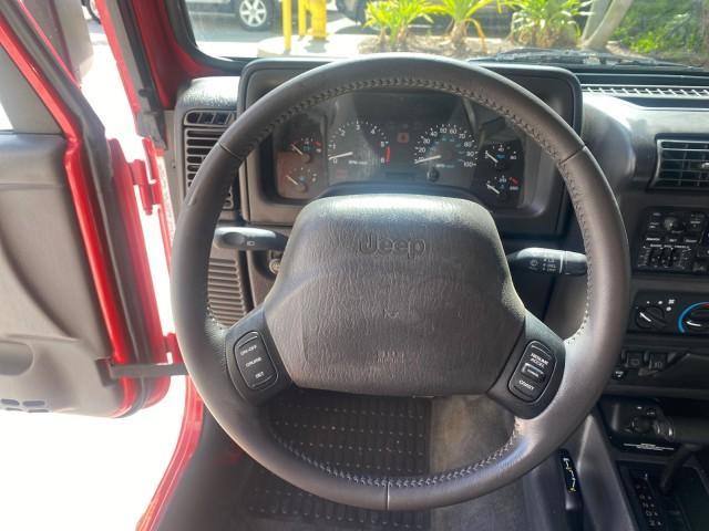 1999 Flame Red /Agate Jeep Wrangler Sport AUTO AC 4.0 6 CYL LOW MILES 92,727 (1J4FY19S2XP) with an 4.0L SMPI I6 Power Tech Engine engine, Automatic transmission, located at 4701 North Dixie Hwy, Pompano Beach, FL, 33064, (954) 422-2889, 26.240938, -80.123474 - OUR WEBPAGE FLORIDACARS1.COM HAS OVER 100 PHOTOS AND FREE CARFAX LINK 1999 Jeep Wrangler Sport 4WD Utility 4.0L I6 F Gasoline 20 MPG Rear Wheel Drive w/ 4X4 Features 4WD/AWD Air Conditioning Alloy Wheels AM/FM Stereo Automatic Transmission CD Audio Cloth Seats Cruise Control Running Boards Soft Top- Photo#51