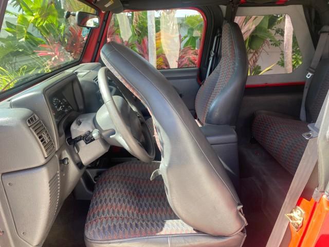 1999 Flame Red /Agate Jeep Wrangler Sport AUTO AC 4.0 6 CYL LOW MILES 92,727 (1J4FY19S2XP) with an 4.0L SMPI I6 Power Tech Engine engine, Automatic transmission, located at 4701 North Dixie Hwy, Pompano Beach, FL, 33064, (954) 422-2889, 26.240938, -80.123474 - OUR WEBPAGE FLORIDACARS1.COM HAS OVER 100 PHOTOS AND FREE CARFAX LINK 1999 Jeep Wrangler Sport 4WD Utility 4.0L I6 F Gasoline 20 MPG Rear Wheel Drive w/ 4X4 Features 4WD/AWD Air Conditioning Alloy Wheels AM/FM Stereo Automatic Transmission CD Audio Cloth Seats Cruise Control Running Boards Soft Top- Photo#69