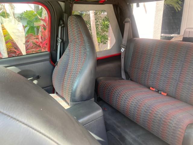1999 Flame Red /Agate Jeep Wrangler Sport AUTO AC 4.0 6 CYL LOW MILES 92,727 (1J4FY19S2XP) with an 4.0L SMPI I6 Power Tech Engine engine, Automatic transmission, located at 4701 North Dixie Hwy, Pompano Beach, FL, 33064, (954) 422-2889, 26.240938, -80.123474 - OUR WEBPAGE FLORIDACARS1.COM HAS OVER 100 PHOTOS AND FREE CARFAX LINK 1999 Jeep Wrangler Sport 4WD Utility 4.0L I6 F Gasoline 20 MPG Rear Wheel Drive w/ 4X4 Features 4WD/AWD Air Conditioning Alloy Wheels AM/FM Stereo Automatic Transmission CD Audio Cloth Seats Cruise Control Running Boards Soft Top- Photo#70