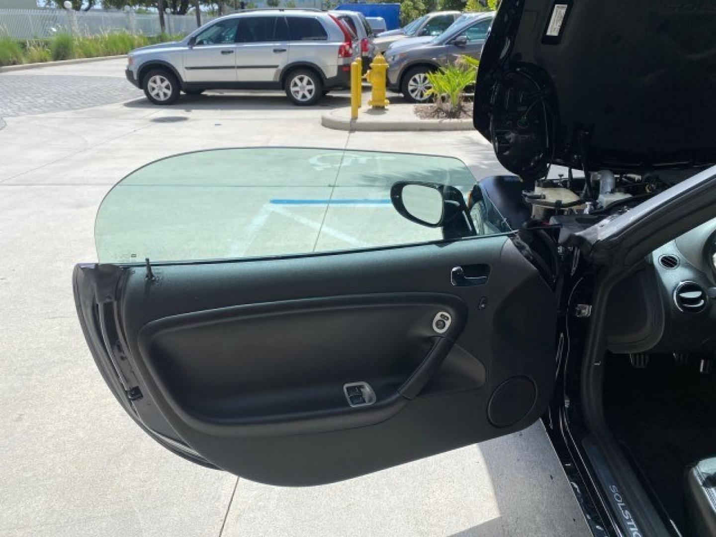 2008 Mysterious (Black) /Ebony Pontiac Solstice GXP 2.0 ECOTURBO LOW MILES 26,059 (1G2MG35X28Y) with an Turbo Ecotec 2.0L VVT DOHC 4-Cyl Aluminum Engine engine, Manual transmission, located at 4701 North Dixie Hwy, Pompano Beach, FL, 33064, (954) 422-2889, 26.240938, -80.123474 - OUR WEBPAGE FLORIDACARS1.COM HAS OVER 100 PHOTOS AND FREE CARFAX LINK 2008 Pontiac Solstice GXP Convertible 2.0L I4 F Gasoline 31 MPG Rear Wheel Drive Features ABS Brakes Air Conditioning Alloy Wheels AM/FM Stereo Auxiliary Audio Input CD Audio Convenience Package Cruise Control Leather Seats Manual- Photo#9