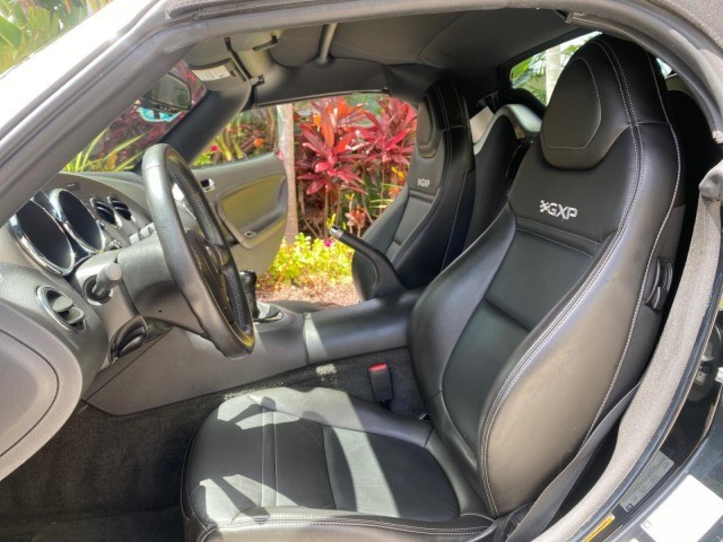 2008 Mysterious (Black) /Ebony Pontiac Solstice GXP 2.0 ECOTURBO LOW MILES 26,059 (1G2MG35X28Y) with an Turbo Ecotec 2.0L VVT DOHC 4-Cyl Aluminum Engine engine, Manual transmission, located at 4701 North Dixie Hwy, Pompano Beach, FL, 33064, (954) 422-2889, 26.240938, -80.123474 - OUR WEBPAGE FLORIDACARS1.COM HAS OVER 100 PHOTOS AND FREE CARFAX LINK 2008 Pontiac Solstice GXP Convertible 2.0L I4 F Gasoline 31 MPG Rear Wheel Drive Features ABS Brakes Air Conditioning Alloy Wheels AM/FM Stereo Auxiliary Audio Input CD Audio Convenience Package Cruise Control Leather Seats Manual- Photo#10