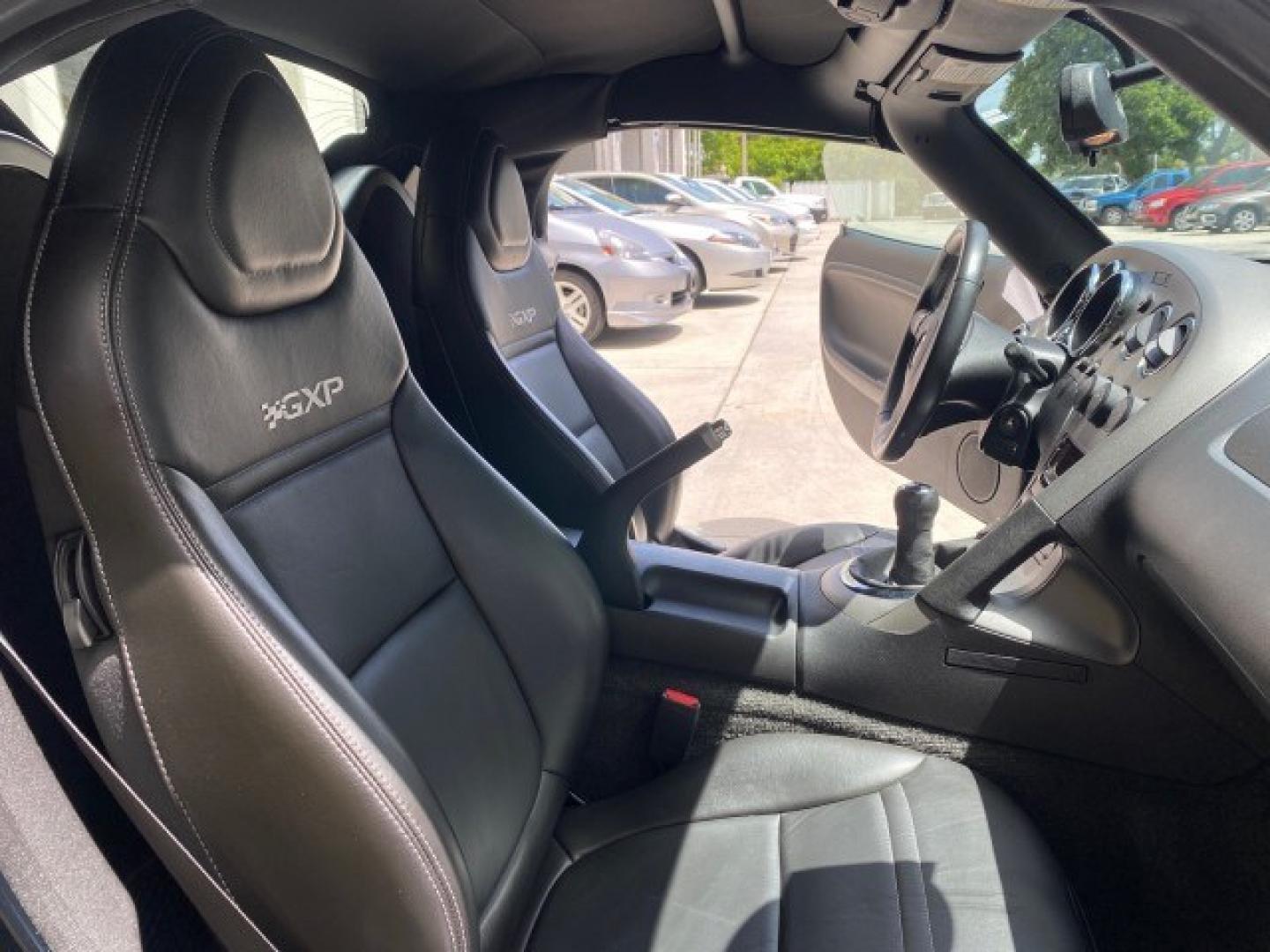 2008 Mysterious (Black) /Ebony Pontiac Solstice GXP 2.0 ECOTURBO LOW MILES 26,059 (1G2MG35X28Y) with an Turbo Ecotec 2.0L VVT DOHC 4-Cyl Aluminum Engine engine, Manual transmission, located at 4701 North Dixie Hwy, Pompano Beach, FL, 33064, (954) 422-2889, 26.240938, -80.123474 - OUR WEBPAGE FLORIDACARS1.COM HAS OVER 100 PHOTOS AND FREE CARFAX LINK 2008 Pontiac Solstice GXP Convertible 2.0L I4 F Gasoline 31 MPG Rear Wheel Drive Features ABS Brakes Air Conditioning Alloy Wheels AM/FM Stereo Auxiliary Audio Input CD Audio Convenience Package Cruise Control Leather Seats Manual- Photo#12