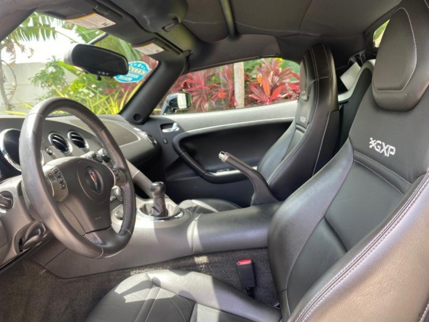 2008 Mysterious (Black) /Ebony Pontiac Solstice GXP 2.0 ECOTURBO LOW MILES 26,059 (1G2MG35X28Y) with an Turbo Ecotec 2.0L VVT DOHC 4-Cyl Aluminum Engine engine, Manual transmission, located at 4701 North Dixie Hwy, Pompano Beach, FL, 33064, (954) 422-2889, 26.240938, -80.123474 - OUR WEBPAGE FLORIDACARS1.COM HAS OVER 100 PHOTOS AND FREE CARFAX LINK 2008 Pontiac Solstice GXP Convertible 2.0L I4 F Gasoline 31 MPG Rear Wheel Drive Features ABS Brakes Air Conditioning Alloy Wheels AM/FM Stereo Auxiliary Audio Input CD Audio Convenience Package Cruise Control Leather Seats Manual- Photo#45