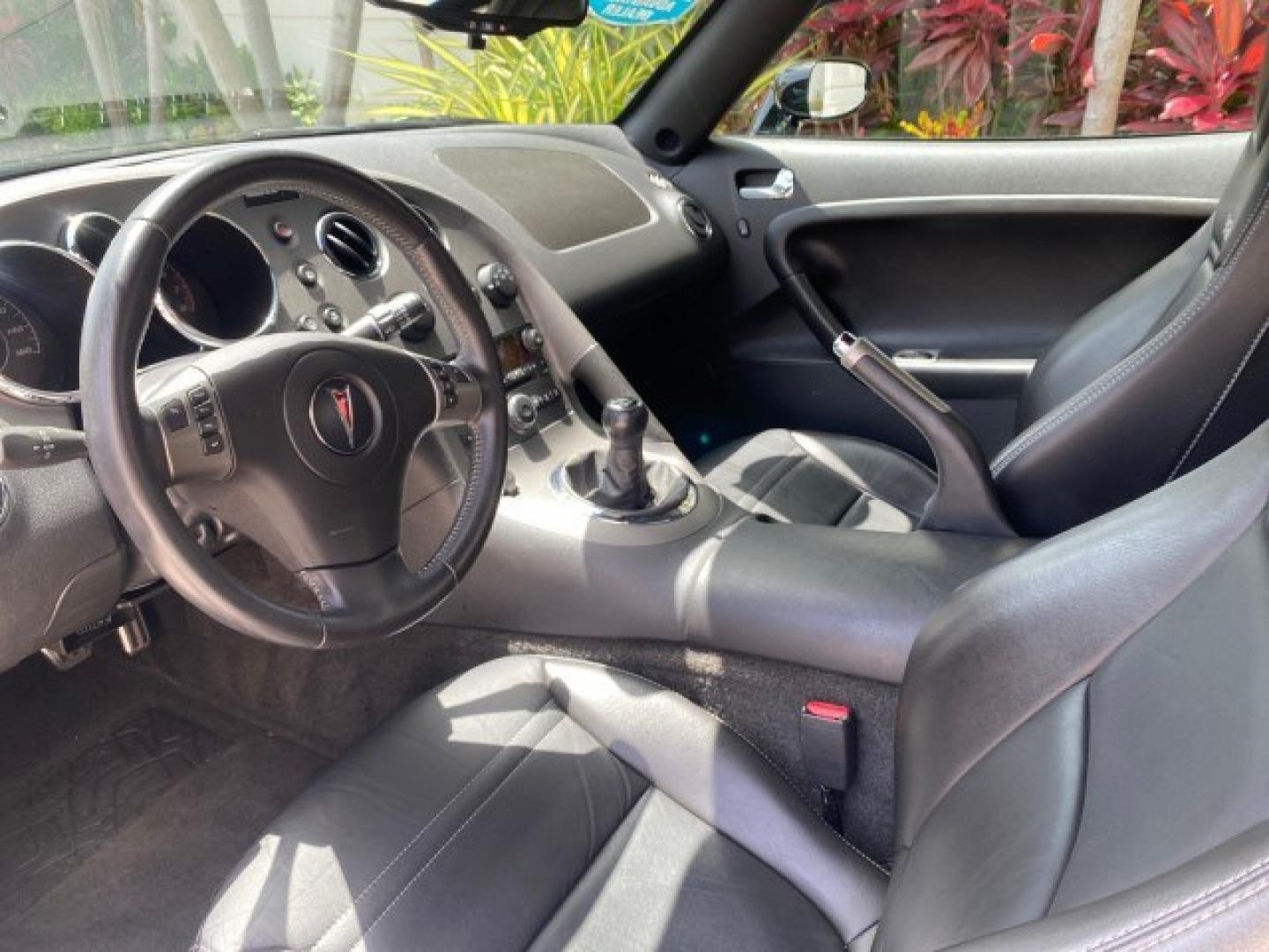 2008 Mysterious (Black) /Ebony Pontiac Solstice GXP 2.0 ECOTURBO LOW MILES 26,059 (1G2MG35X28Y) with an Turbo Ecotec 2.0L VVT DOHC 4-Cyl Aluminum Engine engine, Manual transmission, located at 4701 North Dixie Hwy, Pompano Beach, FL, 33064, (954) 422-2889, 26.240938, -80.123474 - OUR WEBPAGE FLORIDACARS1.COM HAS OVER 100 PHOTOS AND FREE CARFAX LINK 2008 Pontiac Solstice GXP Convertible 2.0L I4 F Gasoline 31 MPG Rear Wheel Drive Features ABS Brakes Air Conditioning Alloy Wheels AM/FM Stereo Auxiliary Audio Input CD Audio Convenience Package Cruise Control Leather Seats Manual- Photo#46