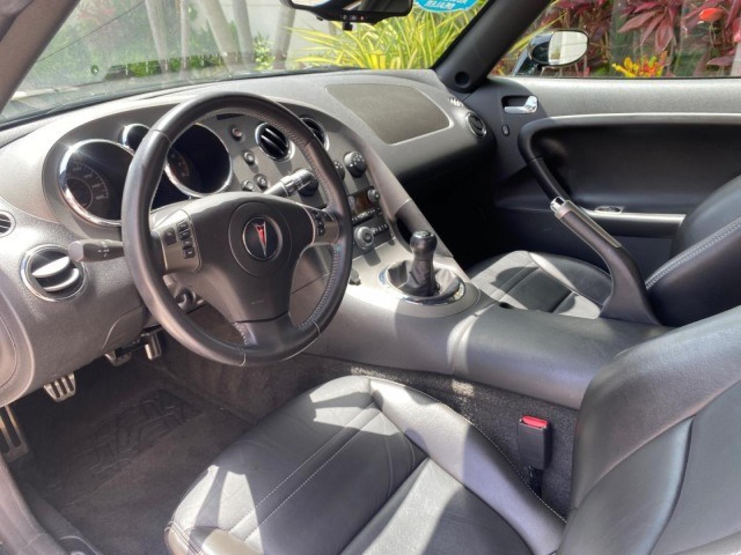 2008 Mysterious (Black) /Ebony Pontiac Solstice GXP 2.0 ECOTURBO LOW MILES 26,059 (1G2MG35X28Y) with an Turbo Ecotec 2.0L VVT DOHC 4-Cyl Aluminum Engine engine, Manual transmission, located at 4701 North Dixie Hwy, Pompano Beach, FL, 33064, (954) 422-2889, 26.240938, -80.123474 - OUR WEBPAGE FLORIDACARS1.COM HAS OVER 100 PHOTOS AND FREE CARFAX LINK 2008 Pontiac Solstice GXP Convertible 2.0L I4 F Gasoline 31 MPG Rear Wheel Drive Features ABS Brakes Air Conditioning Alloy Wheels AM/FM Stereo Auxiliary Audio Input CD Audio Convenience Package Cruise Control Leather Seats Manual- Photo#47