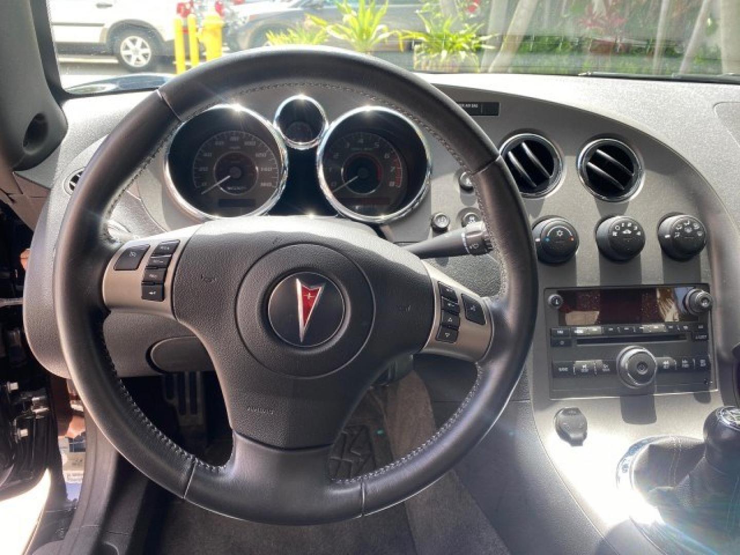 2008 Mysterious (Black) /Ebony Pontiac Solstice GXP 2.0 ECOTURBO LOW MILES 26,059 (1G2MG35X28Y) with an Turbo Ecotec 2.0L VVT DOHC 4-Cyl Aluminum Engine engine, Manual transmission, located at 4701 North Dixie Hwy, Pompano Beach, FL, 33064, (954) 422-2889, 26.240938, -80.123474 - OUR WEBPAGE FLORIDACARS1.COM HAS OVER 100 PHOTOS AND FREE CARFAX LINK 2008 Pontiac Solstice GXP Convertible 2.0L I4 F Gasoline 31 MPG Rear Wheel Drive Features ABS Brakes Air Conditioning Alloy Wheels AM/FM Stereo Auxiliary Audio Input CD Audio Convenience Package Cruise Control Leather Seats Manual- Photo#50