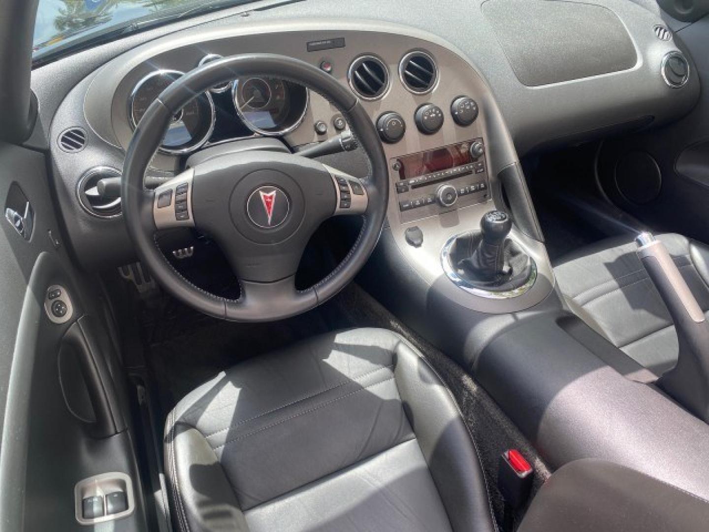 2008 Mysterious (Black) /Ebony Pontiac Solstice GXP 2.0 ECOTURBO LOW MILES 26,059 (1G2MG35X28Y) with an Turbo Ecotec 2.0L VVT DOHC 4-Cyl Aluminum Engine engine, Manual transmission, located at 4701 North Dixie Hwy, Pompano Beach, FL, 33064, (954) 422-2889, 26.240938, -80.123474 - OUR WEBPAGE FLORIDACARS1.COM HAS OVER 100 PHOTOS AND FREE CARFAX LINK 2008 Pontiac Solstice GXP Convertible 2.0L I4 F Gasoline 31 MPG Rear Wheel Drive Features ABS Brakes Air Conditioning Alloy Wheels AM/FM Stereo Auxiliary Audio Input CD Audio Convenience Package Cruise Control Leather Seats Manual- Photo#96