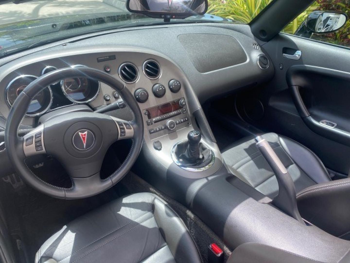 2008 Mysterious (Black) /Ebony Pontiac Solstice GXP 2.0 ECOTURBO LOW MILES 26,059 (1G2MG35X28Y) with an Turbo Ecotec 2.0L VVT DOHC 4-Cyl Aluminum Engine engine, Manual transmission, located at 4701 North Dixie Hwy, Pompano Beach, FL, 33064, (954) 422-2889, 26.240938, -80.123474 - OUR WEBPAGE FLORIDACARS1.COM HAS OVER 100 PHOTOS AND FREE CARFAX LINK 2008 Pontiac Solstice GXP Convertible 2.0L I4 F Gasoline 31 MPG Rear Wheel Drive Features ABS Brakes Air Conditioning Alloy Wheels AM/FM Stereo Auxiliary Audio Input CD Audio Convenience Package Cruise Control Leather Seats Manual- Photo#97