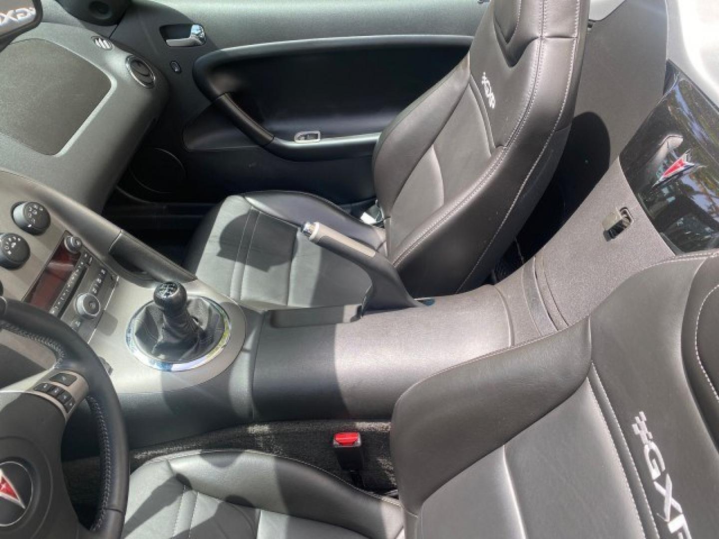 2008 Mysterious (Black) /Ebony Pontiac Solstice GXP 2.0 ECOTURBO LOW MILES 26,059 (1G2MG35X28Y) with an Turbo Ecotec 2.0L VVT DOHC 4-Cyl Aluminum Engine engine, Manual transmission, located at 4701 North Dixie Hwy, Pompano Beach, FL, 33064, (954) 422-2889, 26.240938, -80.123474 - OUR WEBPAGE FLORIDACARS1.COM HAS OVER 100 PHOTOS AND FREE CARFAX LINK 2008 Pontiac Solstice GXP Convertible 2.0L I4 F Gasoline 31 MPG Rear Wheel Drive Features ABS Brakes Air Conditioning Alloy Wheels AM/FM Stereo Auxiliary Audio Input CD Audio Convenience Package Cruise Control Leather Seats Manual- Photo#98