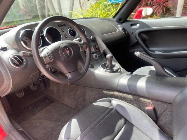 2007 Aggressive (Victory Red) /Ebony Pontiac Solstice LOW MILES 38,147 5SPD AC (1G2MB35B77Y) with an Ecotec 2.4L VVT DOHC 4-Cyl SFI Aluminum Engine engine, Manual transmission, located at 4701 North Dixie Hwy, Pompano Beach, FL, 33064, (954) 422-2889, 26.240938, -80.123474 - OUR WEBPAGE FLORIDACARS1.COM HAS OVER 100 PHOTOS AND FREE CARFAX LINK 2007 Pontiac Solstice Convertible 2.4L I4 F DOHC Gasoline 28 MPG Rear Wheel Drive Features Air Conditioning Alloy Wheels AM/FM Stereo Auxiliary Audio Input CD Audio Cruise Control Leather Seats Manual Transmission Power Locks Powe- Photo#48