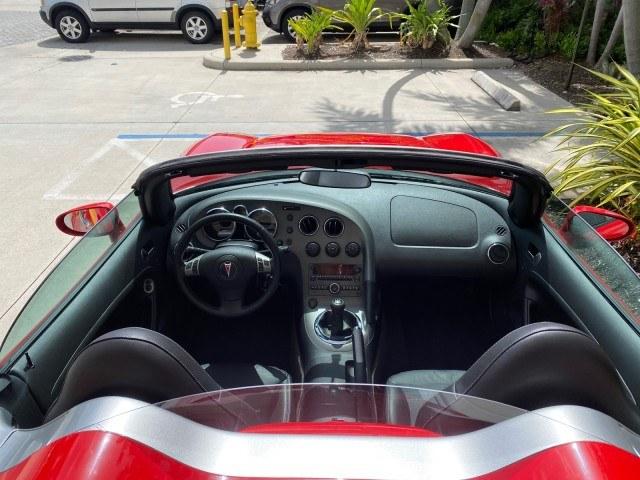 2007 Aggressive (Victory Red) /Ebony Pontiac Solstice LOW MILES 38,147 5SPD AC (1G2MB35B77Y) with an Ecotec 2.4L VVT DOHC 4-Cyl SFI Aluminum Engine engine, Manual transmission, located at 4701 North Dixie Hwy, Pompano Beach, FL, 33064, (954) 422-2889, 26.240938, -80.123474 - OUR WEBPAGE FLORIDACARS1.COM HAS OVER 100 PHOTOS AND FREE CARFAX LINK 2007 Pontiac Solstice Convertible 2.4L I4 F DOHC Gasoline 28 MPG Rear Wheel Drive Features Air Conditioning Alloy Wheels AM/FM Stereo Auxiliary Audio Input CD Audio Cruise Control Leather Seats Manual Transmission Power Locks Powe- Photo#96