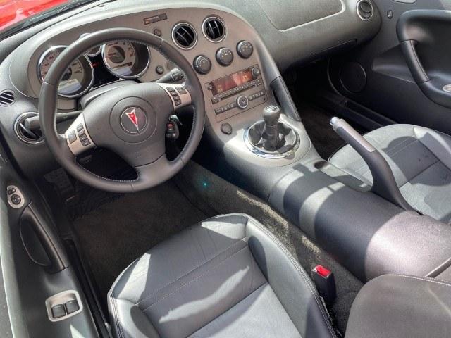 2007 Aggressive (Victory Red) /Ebony Pontiac Solstice LOW MILES 38,147 5SPD AC (1G2MB35B77Y) with an Ecotec 2.4L VVT DOHC 4-Cyl SFI Aluminum Engine engine, Manual transmission, located at 4701 North Dixie Hwy, Pompano Beach, FL, 33064, (954) 422-2889, 26.240938, -80.123474 - OUR WEBPAGE FLORIDACARS1.COM HAS OVER 100 PHOTOS AND FREE CARFAX LINK 2007 Pontiac Solstice Convertible 2.4L I4 F DOHC Gasoline 28 MPG Rear Wheel Drive Features Air Conditioning Alloy Wheels AM/FM Stereo Auxiliary Audio Input CD Audio Cruise Control Leather Seats Manual Transmission Power Locks Powe- Photo#97