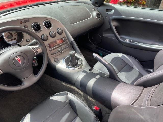 2007 Aggressive (Victory Red) /Ebony Pontiac Solstice LOW MILES 38,147 5SPD AC (1G2MB35B77Y) with an Ecotec 2.4L VVT DOHC 4-Cyl SFI Aluminum Engine engine, Manual transmission, located at 4701 North Dixie Hwy, Pompano Beach, FL, 33064, (954) 422-2889, 26.240938, -80.123474 - OUR WEBPAGE FLORIDACARS1.COM HAS OVER 100 PHOTOS AND FREE CARFAX LINK 2007 Pontiac Solstice Convertible 2.4L I4 F DOHC Gasoline 28 MPG Rear Wheel Drive Features Air Conditioning Alloy Wheels AM/FM Stereo Auxiliary Audio Input CD Audio Cruise Control Leather Seats Manual Transmission Power Locks Powe- Photo#98